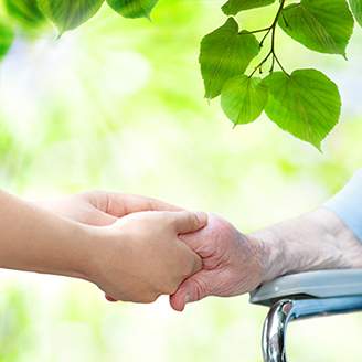 stock-photo-elderly-woman-in-wheel-chair-holding-hands-with-young-caretaker-211362349